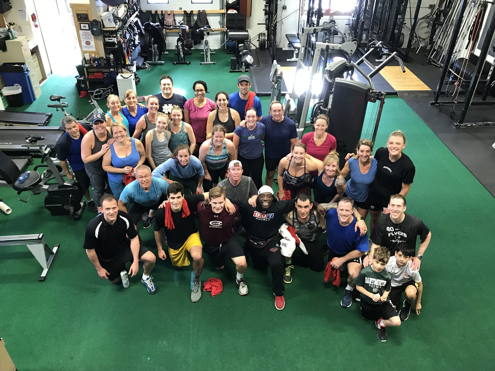 A large group of Thanksgiving bootcamp participants posing together in the gym, 2024